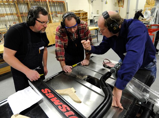 Kevin Watt, 92nd Force Support Squadron woodcraft instructor, explains proper safety measures on the table saw at the wood craft center at Fairchild Air Force Base, Wash., Jan. 10, 2014. The students are part of the woodworking one course, covering the basics of wood crafting. (U.S. Air Force photo by Airman 1st Class Ryan Zeski/Released)