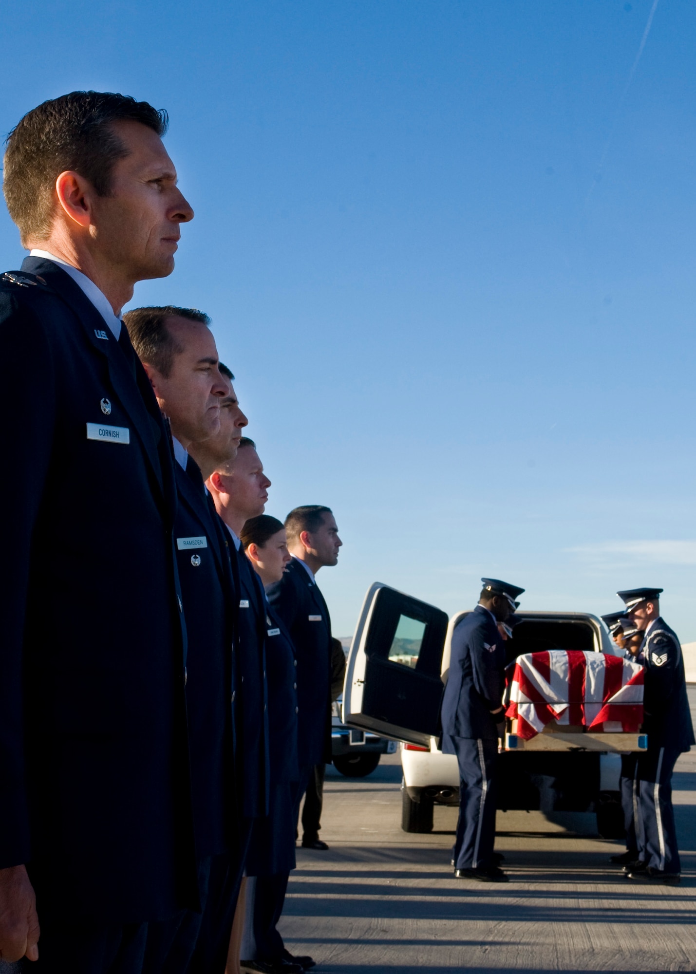 LAS VEGAS -- Nellis Air Force Base, Nev., leadership stand at attention to pay their final respects to Chief Master Sgt. Joseph Hubbard, 53rd Test Management Group superintendent, while the Nellis AFB Honor Guard removes his casket from a hearse during a dignified transfer ceremony Jan. 10, 2014, at McCarran International Airport, Las Vegas. Hubbard entered the Air Force Aug. 21, 1990, initially serving as a security specialist at Barksdale AFB, La. In 1994 he transitioned into communications and computer system operations. He passed away due to natural causes while TDY to Nellis AFB. (U.S. Air Force photo by Airman 1st Class Jason Couillard)