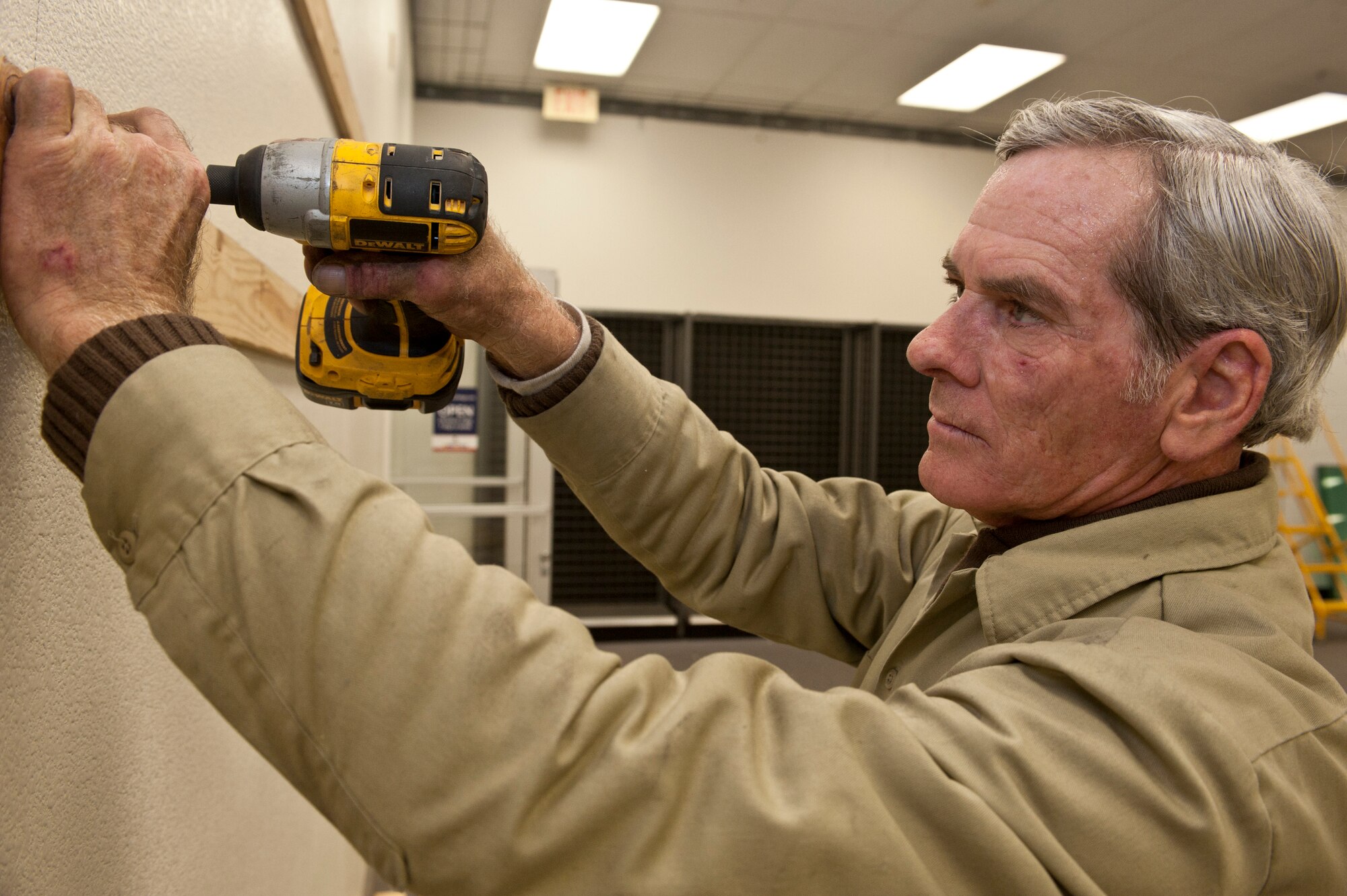 Ray Newson, Universal Restoration general laborer, takes wood beams off the wall in military clothing sales during the start of the store’s renovation Jan. 13, 2014, at Nellis Air Force Base, Nev. The store’s renovation is the first step to giving the Exchange a new look. Future projects for the Exchange will include the renovating and relocation of other stores. (U.S. Air Force photo by Senior Airman Matthew Lancaster)