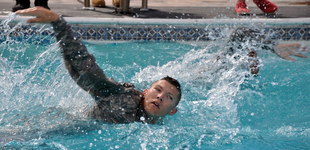 Members of Joint Task Force-Bravo participate in a 100 meter swim while in uniform during testing for the German Armed Forces Proficiency Badge at Soto Cano Air Base, Honduras, Jan. 14, 2014.  Several members of Joint Task Force-Bravo are attempting to qualify for the German Armed Forces Proficiency Badge this week. In order to qualify for the badge, service members must pass both a fitness test and a military training test, administered by a German Sergeant Major. Today, JTF-Bravo members completed an 11x10 meter spring test, a chin-up (flexed arm hang) test, a 1,000 meter run and a 100 meter swim in uniform. The German Armed Forces Proficiency Badge (German: Abzeichen für Leistungen im Truppendienst) is a decoration of the Bundeswehr, the Armed Forces of the Federal Republic of Germany. The decoration can be awarded to all German Soldiers. Allied Soldiers may also be awarded the badge. Any rank may be awarded and wear the badge. In the United States Military the German Armed Forces Proficiency Badge is one of the few approved foreign awards, and it is one of the most sought after awards to achieve. (U.S. Air Force photo by Capt. Zach Anderson)