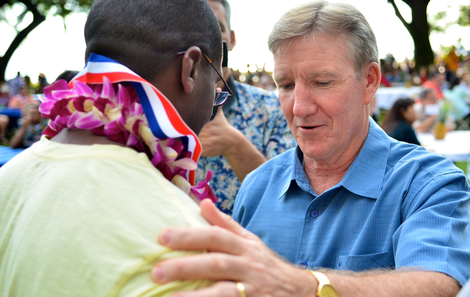 Gen. Hawk Carlisle, Pacific Air Forces commander, congratulates Master Sgt. (ret.) Jems Smith, Air Force Wounded Warrior, at the inaugural Wounded Warrior Pacific Invitational closing ceremony Jan. 11, 2014, in Honolulu, Hawaii. More than 120 wounded-warrior athletes, who’ve fallen ill or were injured in the line of duty, trained in and competed at the 2014 WWPI in adaptive sports – including cycling, track and field, seated volleyball, swimming and wheelchair basketball. The competition is in preparation for the U.S. Olympic Committee's Warrior Games, held at the U.S. Olympic Training Center and the U.S. Air Force Academy in Colorado Springs, Colo. (U.S. Air Force photo/Senior Airman Christopher Stoltz)