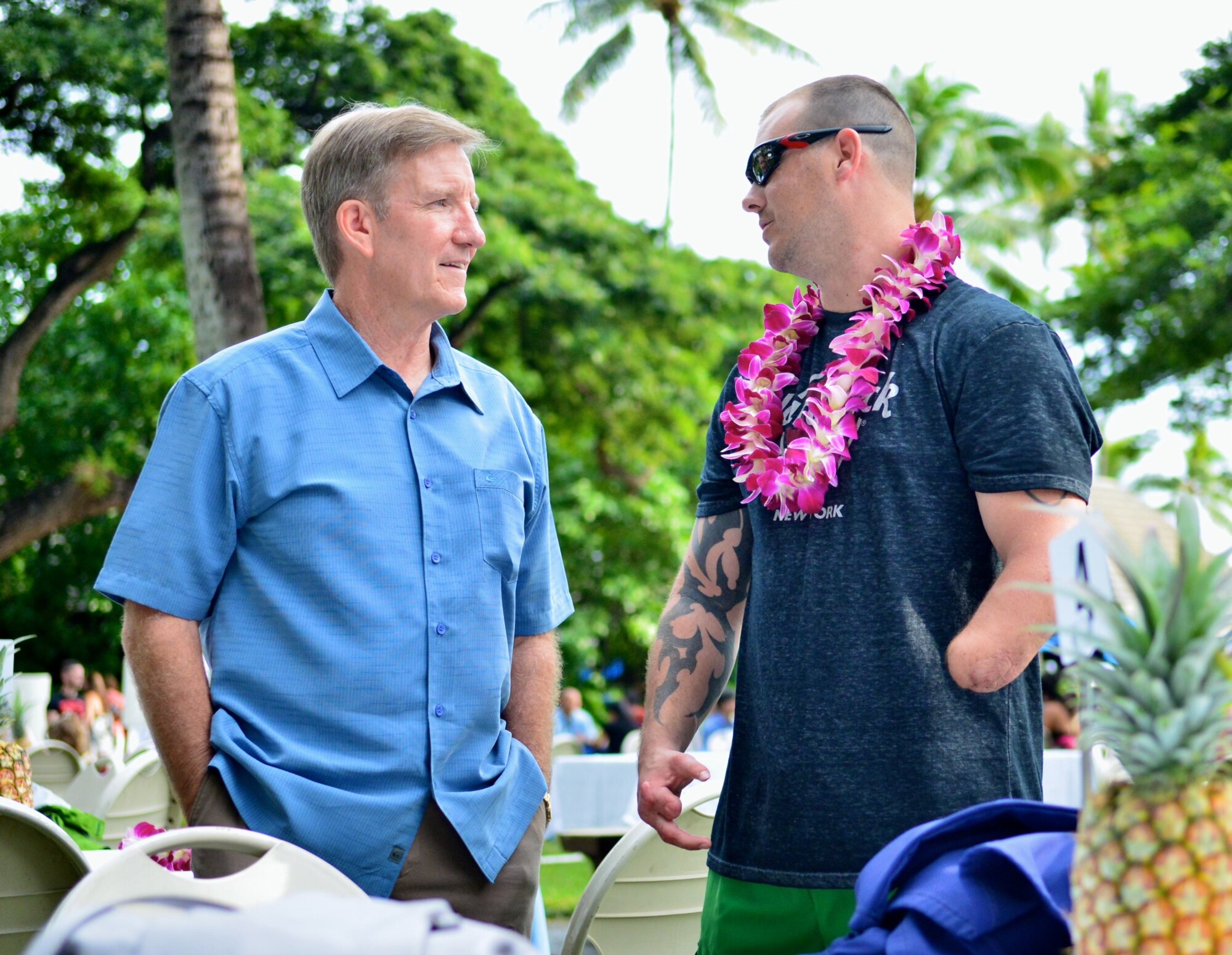 Gen. Hawk Carlisle, Pacific Air Forces commander, speaks with Tech. Sgt. Leonard Anderson, Air Force Wounded Warrior, during the Wounded Warrior Pacific Invitational closing ceremony Jan. 11, 2014, in Honolulu, Hawaii. The 2014 Wounded Warrior Pacific Invitational featured more than 120 wounded-warrior athletes competing in adaptive sports including cycling, track and field, seated volleyball, swimming and wheelchair basketball. Anderson is a military working dog handler who was injured by an improved explosive device while on dismounted patrol in Southwest Asia. Anderson’s story has been featured on the Discovery Channel’s “Glory Hounds.”  (U.S. Air Force photo/Senior Airman Christopher Stoltz)