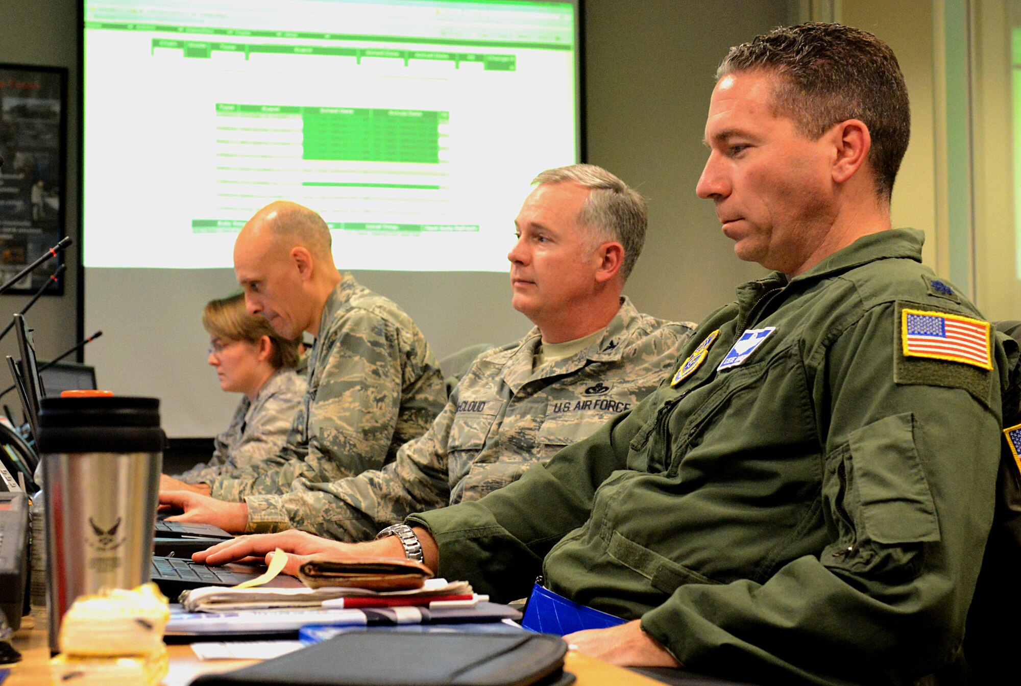 Members of the Crisis Action Team process and relay information to base personnel during an exercise Jan. 10, 2014, Scott Air Force Base, Ill. The exercise evaluated the 375th Air Mobility Wing's ability to process personnel and cargo for contingencies. (U.S. Air Force photo/Senior Airman Jake Eckhardt)