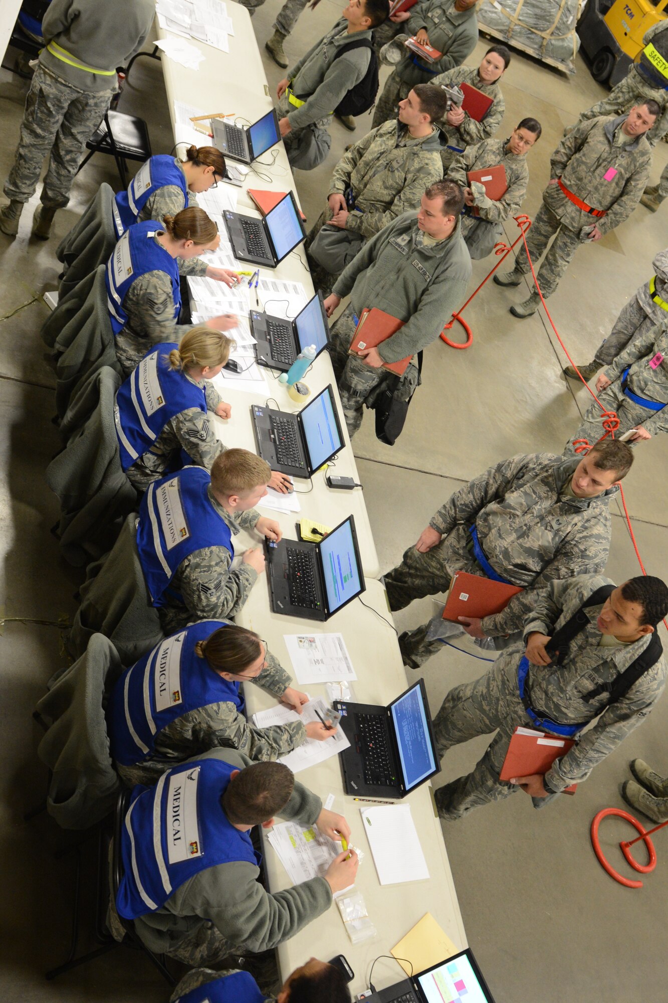 Members participating in the exercise have their records checked in the processing line Jan. 11, 2014 at Scott Air Force Base, Ill. The exercise evaluated the 375th Air Mobility Wing's ability to process personnel and cargo for contingencies. (U.S. Air Force photo/Senior Airman Jake Eckhardt)