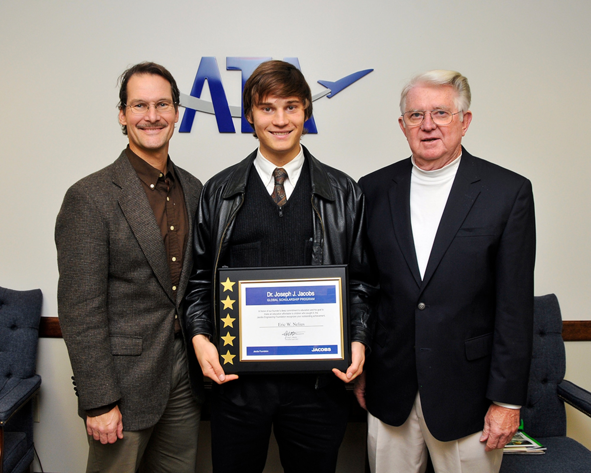 Dr. Joseph J. Jacobs Global Scholarship recipient Eric Nelius (center) displays his scholarship alongside his father Andy Nelius (left), an ATA Engineer, and grandfather Arlis Johnson, a retired Sverdrup employee with AEDC. (Photo by Jacqueline Cowan)