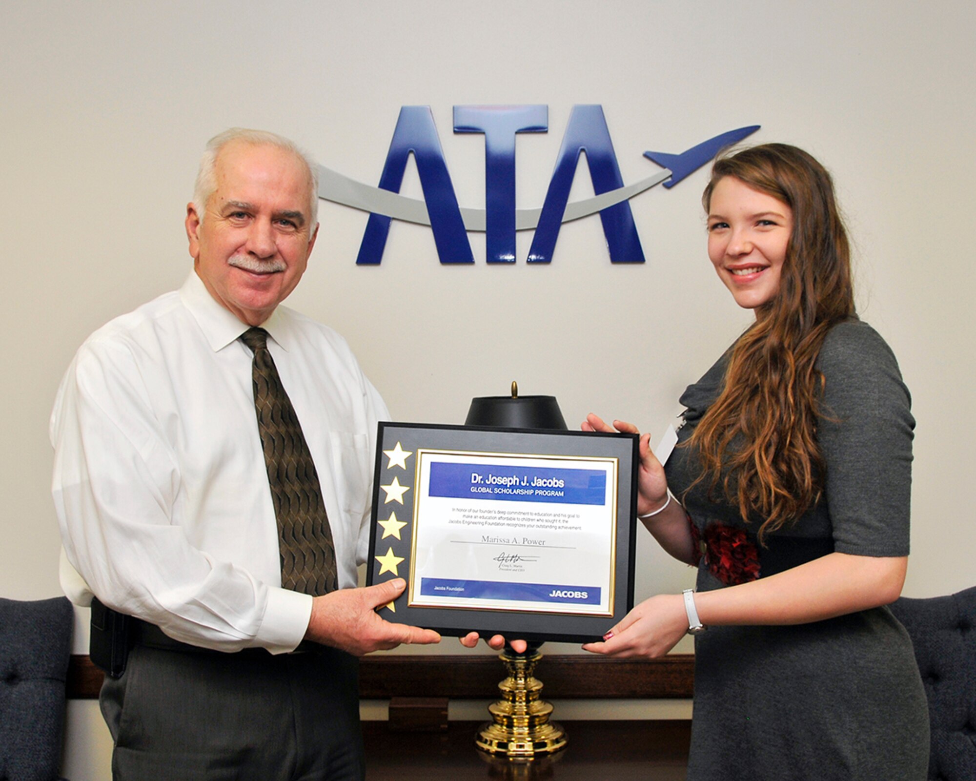 Marissa Power (right), a recipient of the Dr. Joseph J. Jacobs Global Scholarship, accepts her scholarship from ATA General Manager Steve Pearson. (Photo by Jacqueline Cowan)