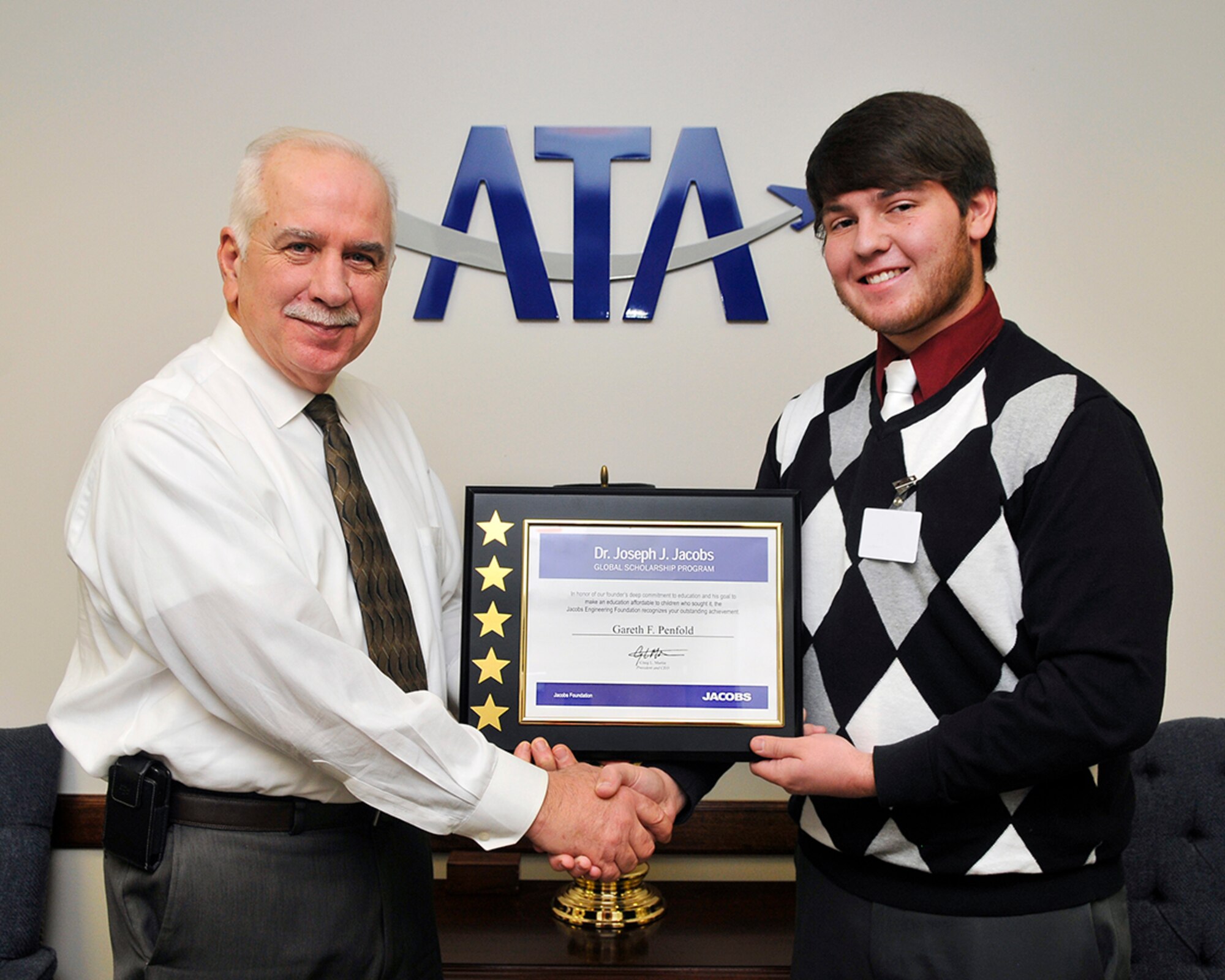 Gareth Penfold (right), a recipient of the Dr. Joseph J. Jacobs Global Scholarship, accepts his scholarship from ATA General Manager Steve Pearson. (Photo by Jacqueline Cowan)