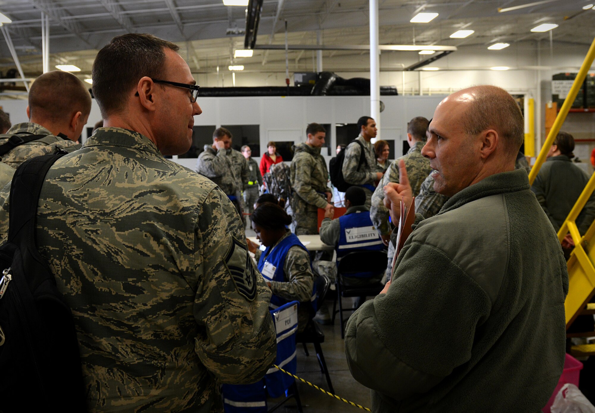Members participating in the exercise wait to have their records checked in the processing line Jan. 11, 2014 at Scott Air Force Base, Ill. The exercise evaluated the 375th Air Mobility Wing's ability to process personnel and cargo for contingencies. (U.S. Air Force photo/Senior Airman Jake Eckhardt)