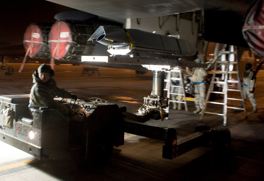 U.S. Air Force Senior Airman Brian Johnson, 7th Aircraft Maintenance Squadron, removes a Joint Air-to-Surface Standoff Missile-Extended Range from a B-1B Lancer Dec. 12, 2013, at Dyess Air Force Base, Texas. The JASSM-ER (AGM-158B) is identical to the baseline JASSM (AGM-158A) on the outside, internally however, a more fuel-efficient turbofan engine and additional fuel on board enables the bomb to destroy targets at more than two-and-a-half times the distance of the original JASSM. (U.S. Air Force photo by Senior Airman Peter Thompson/Released)
