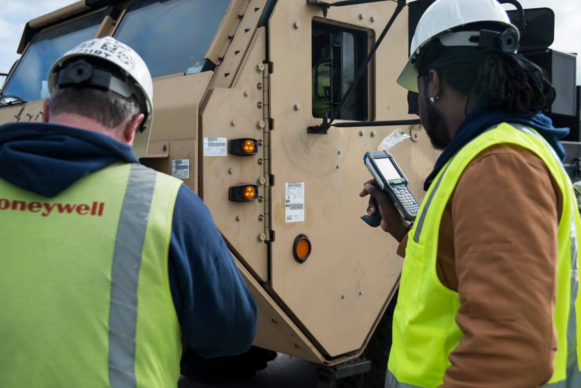 Workers from Honeywell scan cargo after it is offloaded from the USNS Pomeroy (T-AKR-316), Jan. 10, 2014, at the Joint Base Charleston – Weapons Station, S.C.  (U.S. Air Force photo/Senior Airman Ashlee Galloway)