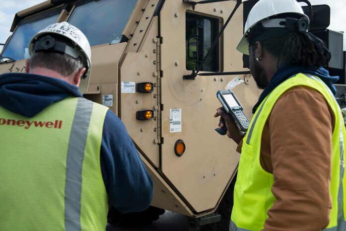 Workers from Honeywell scan cargo after it is offloaded from the USNS Pomeroy (T-AKR-316), Jan. 10, 2014, at the Joint Base Charleston – Weapons Station, S.C.  (U.S. Air Force photo/Senior Airman Ashlee Galloway)