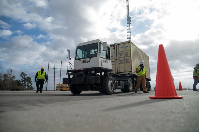 Workers from Honeywell scan in cargo after it is offloaded from the USNS Pomeroy (T-AKR-316) Jan. 10, 2014, at the Joint Base Charleston – Weapons Station, S.C.  (U.S. Air Force photo/Senior Airman Ashlee Galloway)
