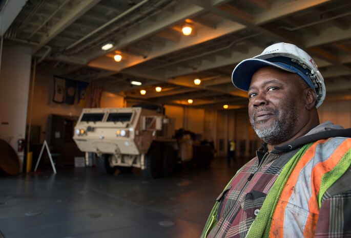 Robert Heyward, International Longshoreman Association flagman, waits for a truck while offloading the USNS Pomeroy (T-AKR-316), Jan. 10, 2014, at the Joint Base Charleston – Weapons Station, S.C.  The Pomeroy is capable of carrying an entire United States Army Armor Task Force; the ship’s decks have space for securing helicopters, tanks, trucks and other large vehicles, including 900-plus associated battalion support vehicles. (U.S. Air Force photo/Senior Airman Ashlee Galloway)