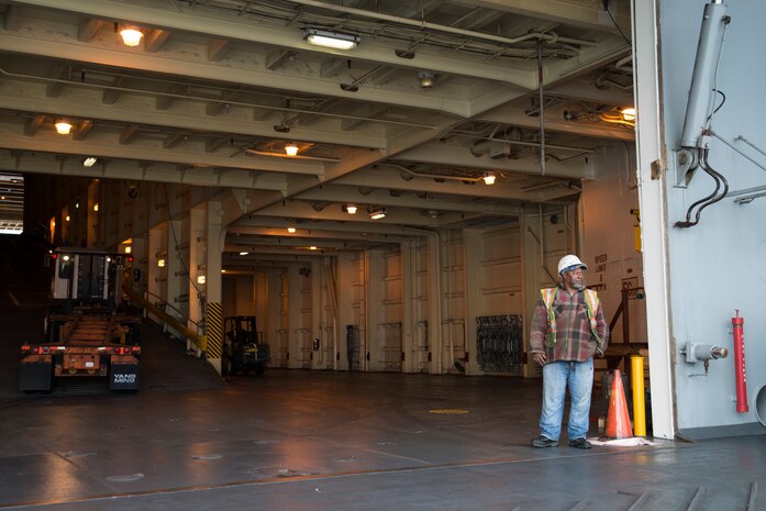 Robert Heyward, International Longshoreman Association flagman, waits for a truck while offloading the USNS Pomeroy (T-AKR-316), Jan. 10, 2014, at the Joint Base Charleston – Weapons Station, S.C.  The Pomeroy is one of 19 large, medium roll-on and roll-off ships belonging to the Navy’s Military Sealift Command. (U.S. Air Force photo/Senior Airman Ashlee Galloway)