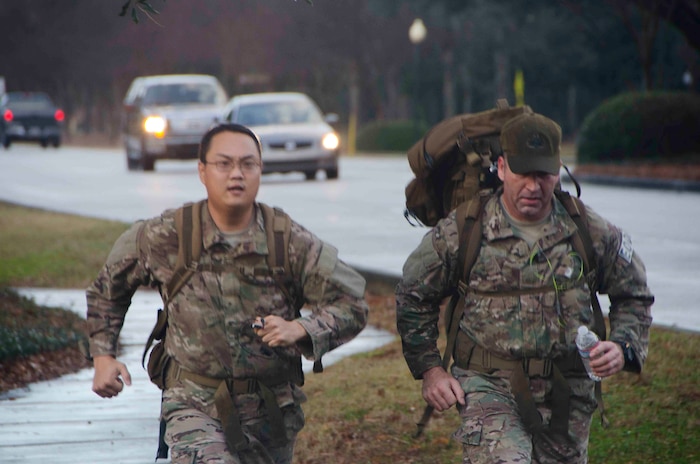 (Right) Staff Sgt. Patrick Puckhaber, 628th Civil Engineer Squadron explosive ordnance disposal journeyman and Master Sgt. Raymond Pomeroy, 628th CES EOD NCOIC of logistics . (U.S. Air Force photo / Staff Sgt. Aaron Thomasson), run the Commander's Challenge wearing 50 pound rucksacks. The Commander's Challenge is held monthly to test Team Charleston's fitness abilities. (U.S. Air Force / Staff Sgt. Aaron Thomasson)