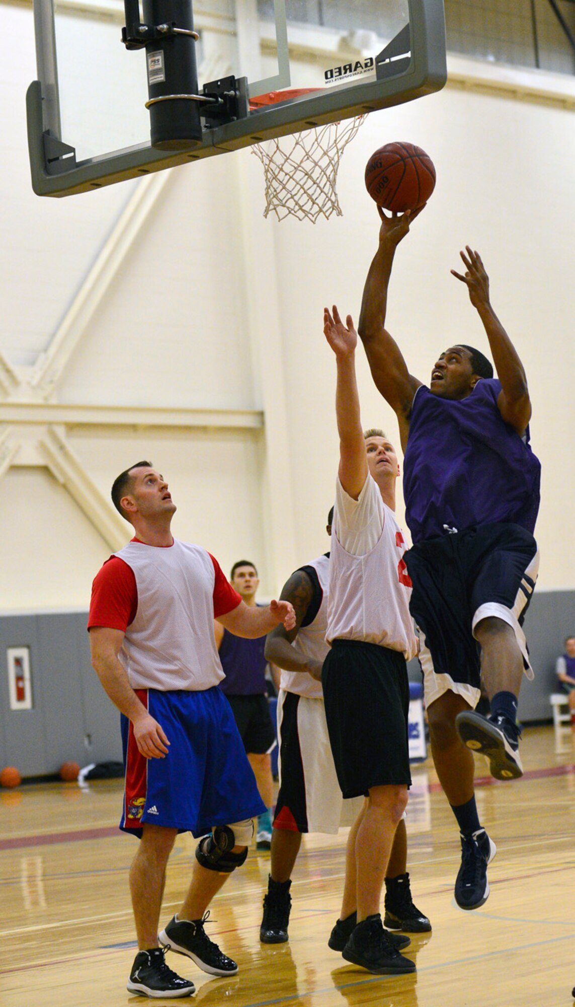 Lavondre Chamberlin, 436th Medical Group guard, goes up for a layup during their season-opening intramural basketball game against the 9th Airlift Squadron Jan. 13, 2013, at the fitness center on Dover Air Force Base, Del. Chamberlin scored a team-high 11 points to lead the 436th MDG to a 52-27 victory against the 9th AS. (U.S. Air Force photo/Airman 1st Class William Johnson)