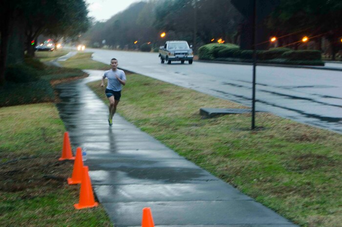 2nd Lt. John Montes, 628th Logistics Readiness Squadron logistics readiness officer, approaches the finish line during the Commander's Challenge Run Jan. 10, 2014, at Joint Base Charleston - Air Base, S.C. Montes finished with a time of 17 minutes, 08 seconds. The Commander's Challenge is held monthly to test Team Charleston's fitness abilities. (U.S. Air Force photo / Staff Sgt. Aaron Thomasson)