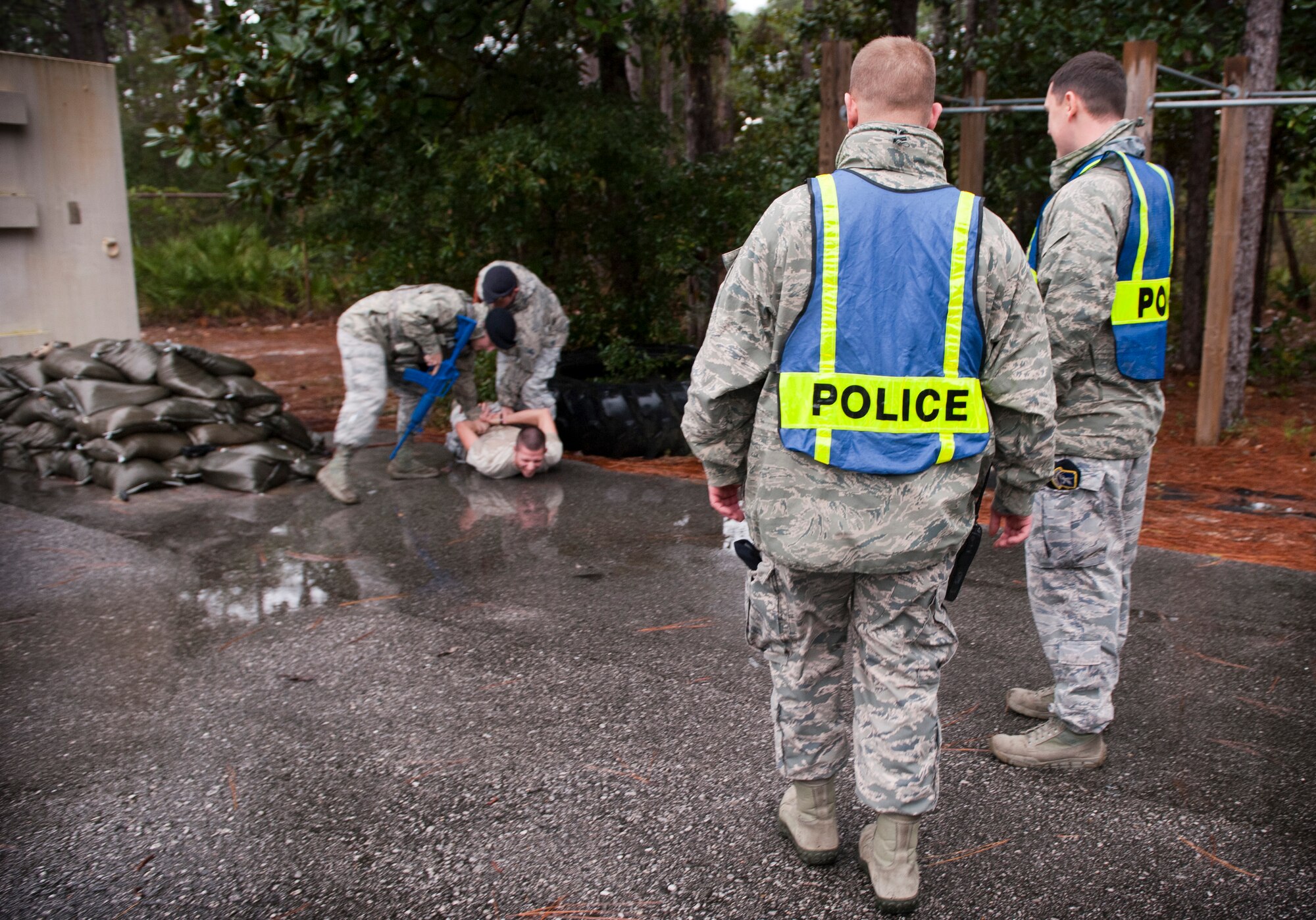 Inspectors from the 1st Special Operations Security Forces Squadron observe SFS Airmen apprehend a suspect during an active shooter exercise on Hurlburt Field, Fla., Jan. 13, 2014. Inspectors evaluated Airmen during the exercise to ensure proper procedures were followed. (U.S. Air Force photo/Senior Airman Krystal M. Garrett)
