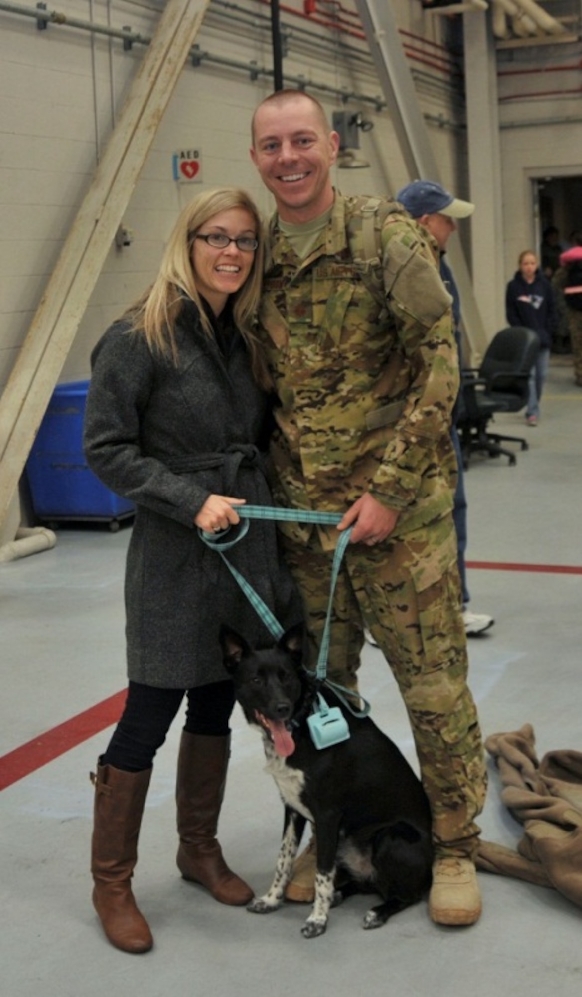 Capt. Trevor Gunderson, 4th Special Operations Squadron pilot, greets his wife, Katie Gunderson, and dog, Zoey, at Hurlburt Field, Fla., Jan. 10, 2014. Multiple families brought their pets to greet their returning Airmen. (U.S. Air Force photo/Airman 1st Class Andrea Posey)