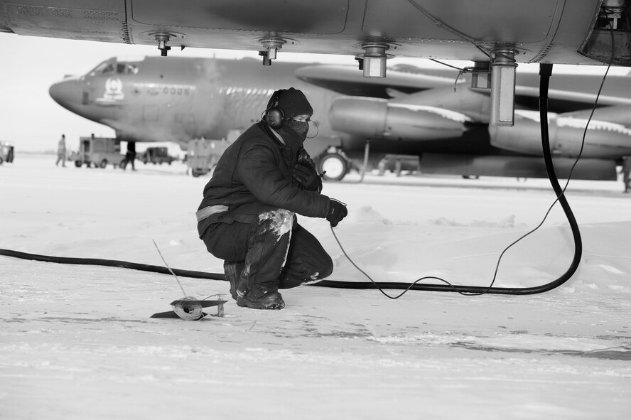 Maintenance Airmen, crew chiefs and flight crews work together in frigid weather conditions to ensure the successful launch of their B-52H Stratofortresses at Minot Air Force Base, N.D. Jan. 7. Crew chiefs and maintenance Airmen work long hours in a difficult and austere environment to meet the demands of their mission. Strong communication skills, job knowledge and working with a tight nit team helps to guarantee their success. (U.S. Air Force photos/Senior Airman Stephanie Sauberan and Airman 1st Class Andrew Crawford)