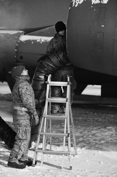 Maintenance Airmen, crew chiefs and flight crews work together in frigid weather conditions to ensure the successful launch of their B-52H Stratofortresses at Minot Air Force Base, N.D. Jan. 7. Crew chiefs and maintenance Airmen work long hours in a difficult and austere environment to meet the demands of their mission. Strong communication skills, job knowledge and working with a tight nit team helps to guarantee their success. (U.S. Air Force photos/Senior Airman Stephanie Sauberan and Airman 1st Class Andrew Crawford)