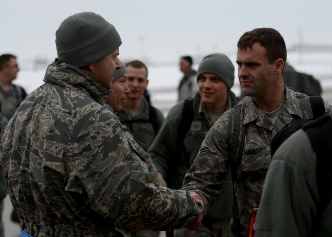Senior Airman Mark Barrett, a reservist in the 419th Fighter Wing, is wished a safe and speedy deployment by Lt. Col. Michael Monfalcone, 388th Equipment Maintenance Squadron commander. Barrett and nearly 300 other Airmen from Hill's active duty 388th Fighter Wing and Air Force Reserve 419th FW recently deployed to the Republic of Korea for several months. (U.S. Air Force photo by Senior Airman Justyn Freeman)