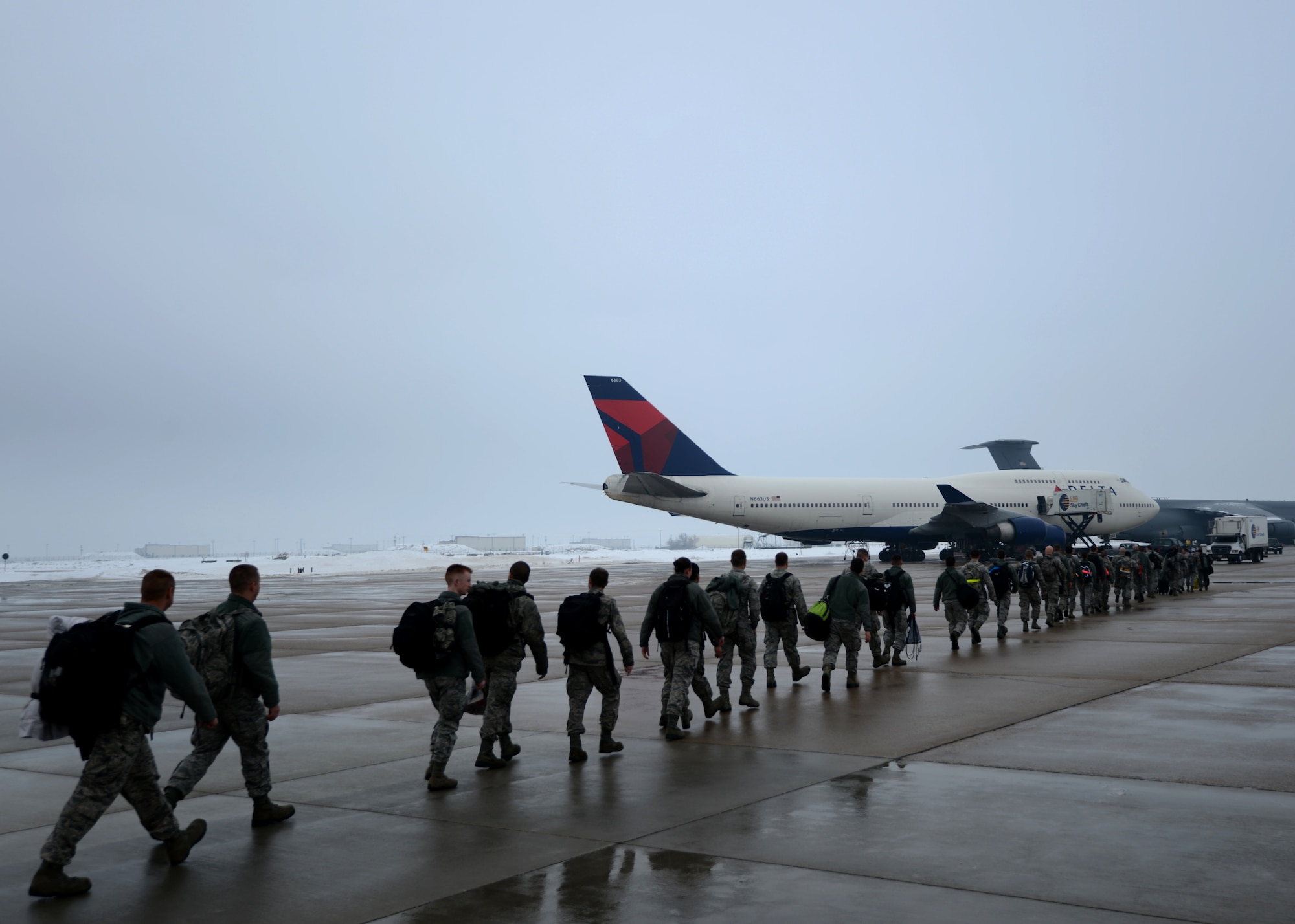 Nearly 300 Airmen from Hill's active duty 388th Fighter Wing and Air Force Reserve 419th FW board a Boeing 747 en route to the Republic of Korea as part of a joint deployment to provide stability and security in the Asia-Pacific region. (U.S. Air Force photo by Senior Airman Justyn Freeman)
