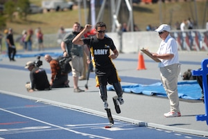 The Warrior Transition Command's mission is to develop, coordinate and integrate the Army's Warrior Care and Transition Program for wounded, ill or injured Soldiers, veterans, and their families or caregivers, to promote success in the force or civilian life. One of the events the command supports is the Warrior Games competition. Pictured here, retired Spc. Luis Puertas, a native of Orlando, Fla., celebrates as he crosses the finish line first after completing the Men's 1500 meter (above the knee single and double amputee) race at the U.S. Air Force Academy in Colorado Springs, Colo., May 14, 2013, during the 2013 Warrior Games.  (U.S. Army photo by Sgt. Brent Powell/Released)