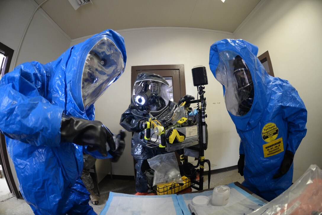 U.S. Army Sgt. 1st Class Kerry Slaba (left), Tech. Sgt. Dustin Clement (middle), and U.S. Army Sgt. Alex Page, 82nd Civil Support Team survey team members, collect samples during a training exercise at Ellsworth Air Force Base, S.D., Jan. 8, 2014. The exercise was designed to test the participants’ ability to respond to a simulated casualty and unknown substance. (U.S. Air Force photo by Senior Airman Zachary Hada/Released)