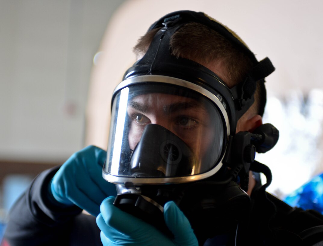 U.S. Army Sgt. Alex Page, 82nd Civil Support Team survey team member, adjusts his gas mask before participating in a training exercise at Ellsworth Air Force Base, S.D., Jan. 8, 2014. The 82nd CST’s mission is to strengthen local and regional terrorism response capabilities during events known or suspected to involve weapons of mass destruction. (U.S. Air Force photo by Senior Airman Zachary Hada/Released)
