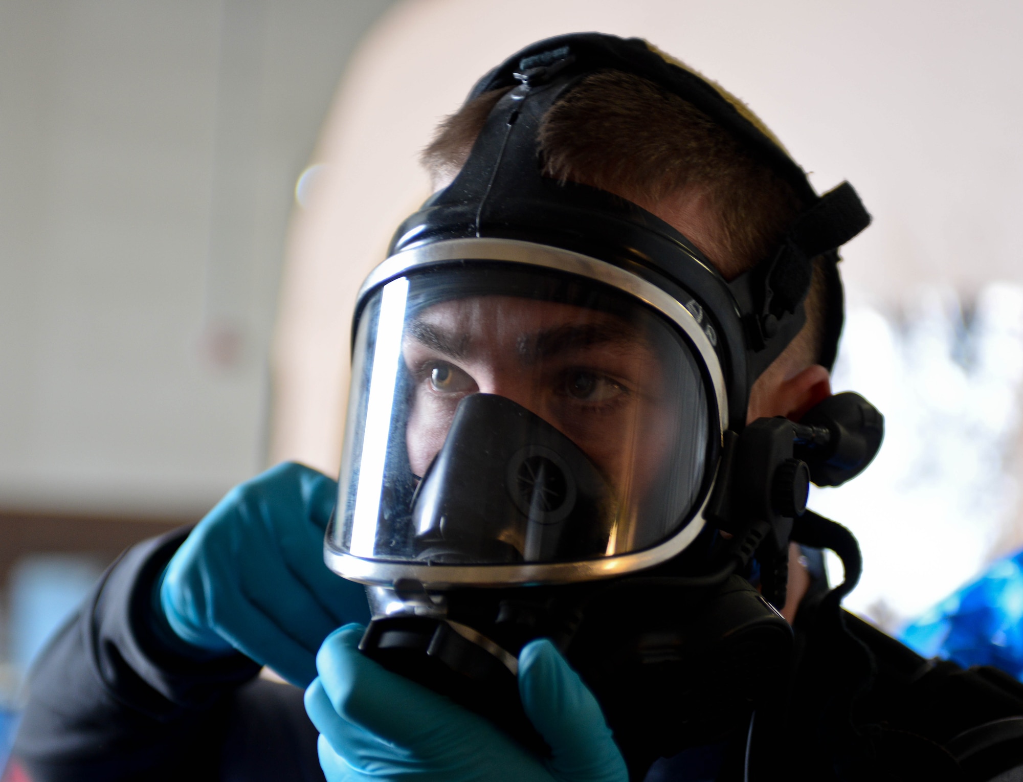 U.S. Army Sgt. Alex Page, 82nd Civil Support Team survey team member, adjusts his gas mask before participating in a training exercise at Ellsworth Air Force Base, S.D., Jan. 8, 2014. The 82nd CST’s mission is to strengthen local and regional terrorism response capabilities during events known or suspected to involve weapons of mass destruction. (U.S. Air Force photo by Senior Airman Zachary Hada/Released)
