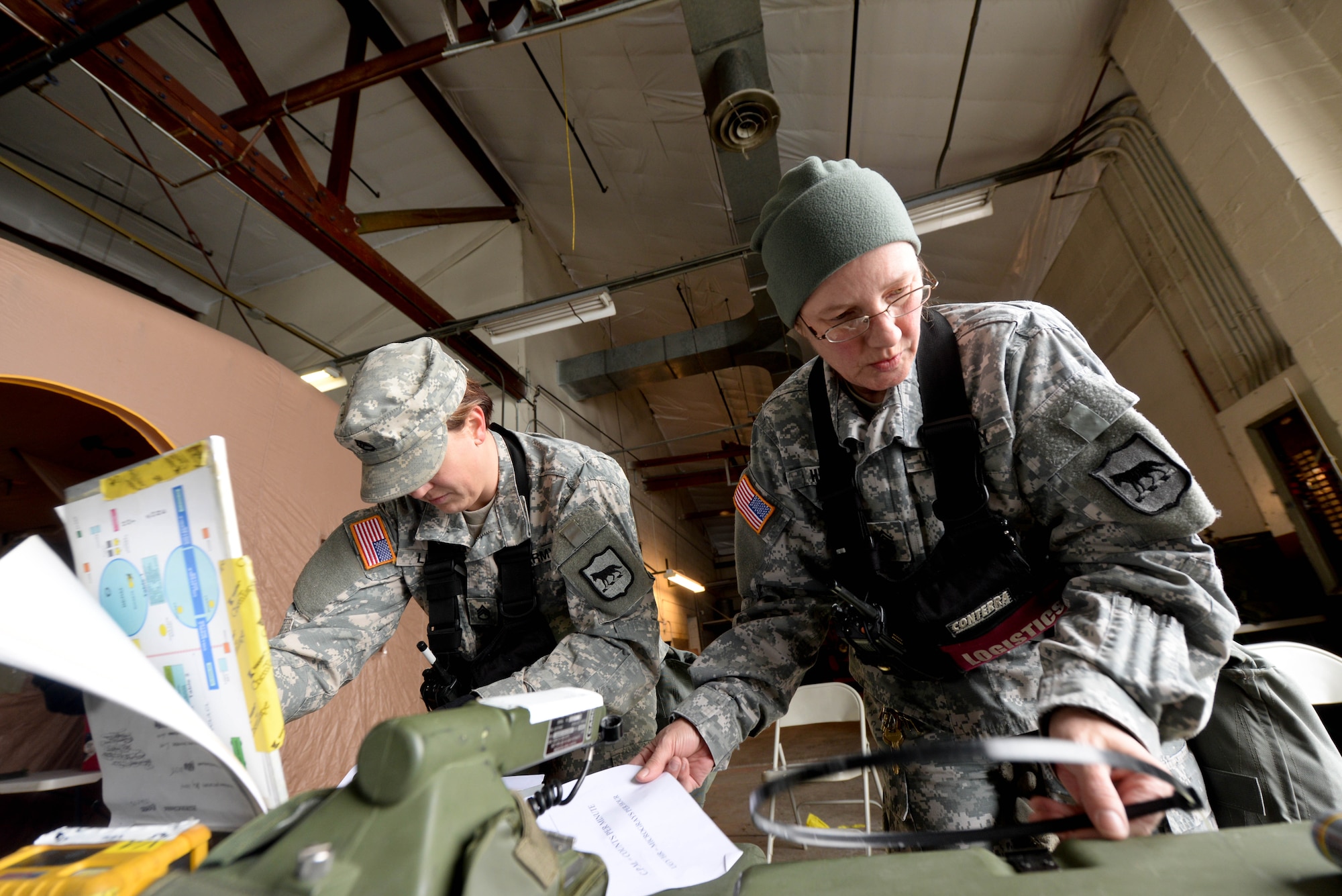 U.S. Army Staff Sgt. Dalene Link (left), 82nd Civil Support Team decontamination NCO in charge, and U.S. Army Sgt. 1st Class Marcia Hento, 82nd CST NCO in charge of supply, setup a decontamination area during a training exercise at Ellsworth Air Force Base, S.D., Jan. 8, 2014. The 82nd CST team consists of 22 individuals who are trained to assist authorities in response to chemical, biological, radiological, nuclear and explosive threats. (U.S. Air Force photo by Senior Airman Zachary Hada/Released)