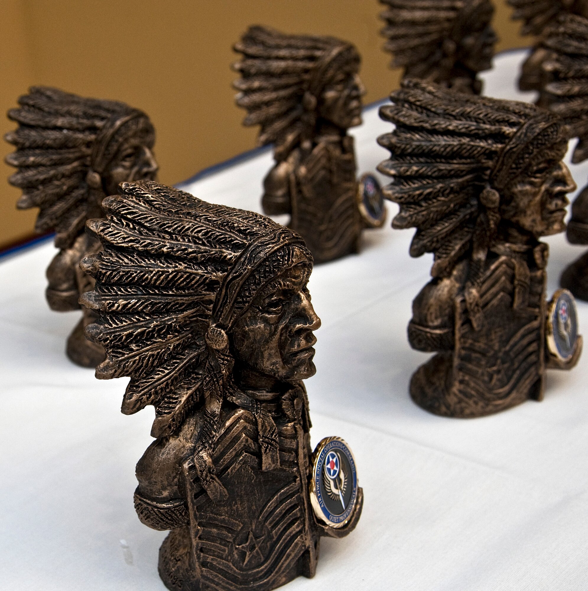 Statues representing inductees’ positions as chief master sergeants rest on a table during the chief master sergeant induction ceremony at the Soundside Club on Hurlburt Field, Fla., Jan. 10, 2014. The evening’s guest speaker, Wayne Norrad, 24th Special Operations Wing program analyst and retired chief master sergeant, and Chief Master Sgt. William Turner, Air Force Special Operations command chief, presented honorees with the statues. (U.S. Air Force photo/Senior Airman Michelle Vickers)