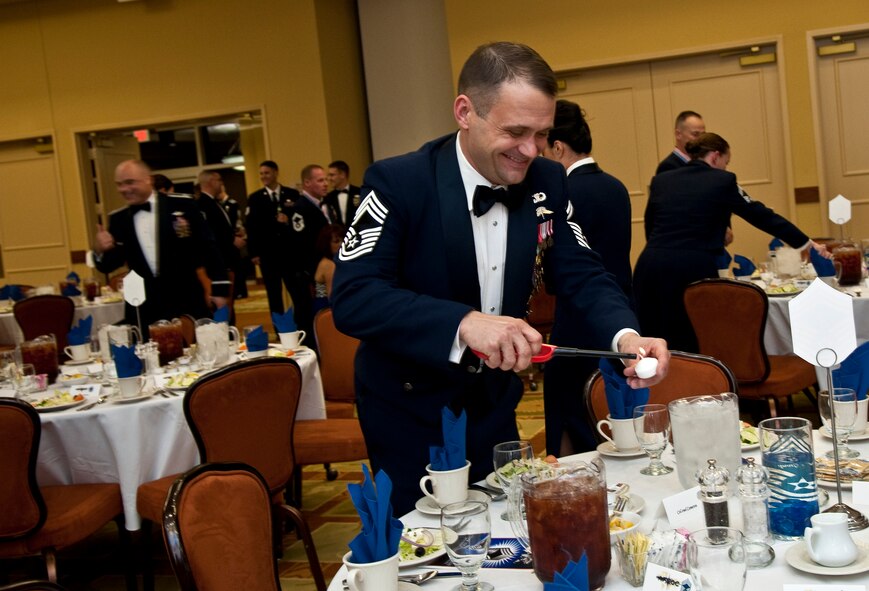 Chief Master Sgt. Ricky Wagner, evening toastmaster, lights candles during the chief master sergeant induction ceremony at the Soundside Club on Hurlburt Field, Fla., Dec. 10, 2014. The Hurlburt Chiefs’ Group hosted the event for 12 new chief master sergeants. (U.S. Air Force photo/Senior Airman Michelle Vickers)