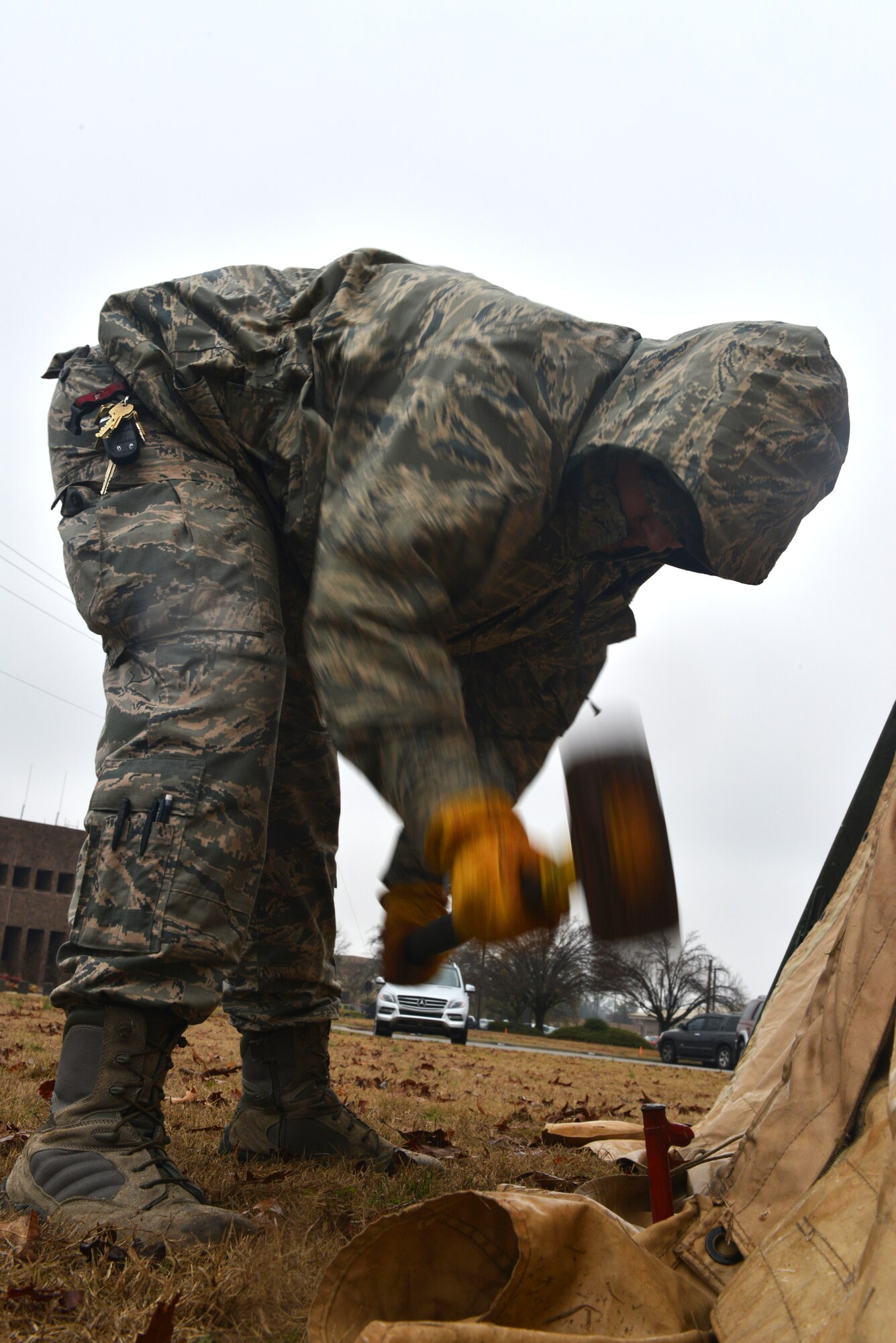 U.S. Air Force Senior Airman Nick Pratt, 20th Civil Engineer Squadron structures craftsman, uses a sledge hammer to drive in a metal stake, Shaw Air Force Base, S.C., Jan. 10, 2014. Pratt, along with several other 20th CES Airmen had set up a TEMPER tent to be used as a simulated chemical containment area for an operational readiness exercise. (U.S. Air Force photo by Airman 1st Class Jensen Stidham/Released)