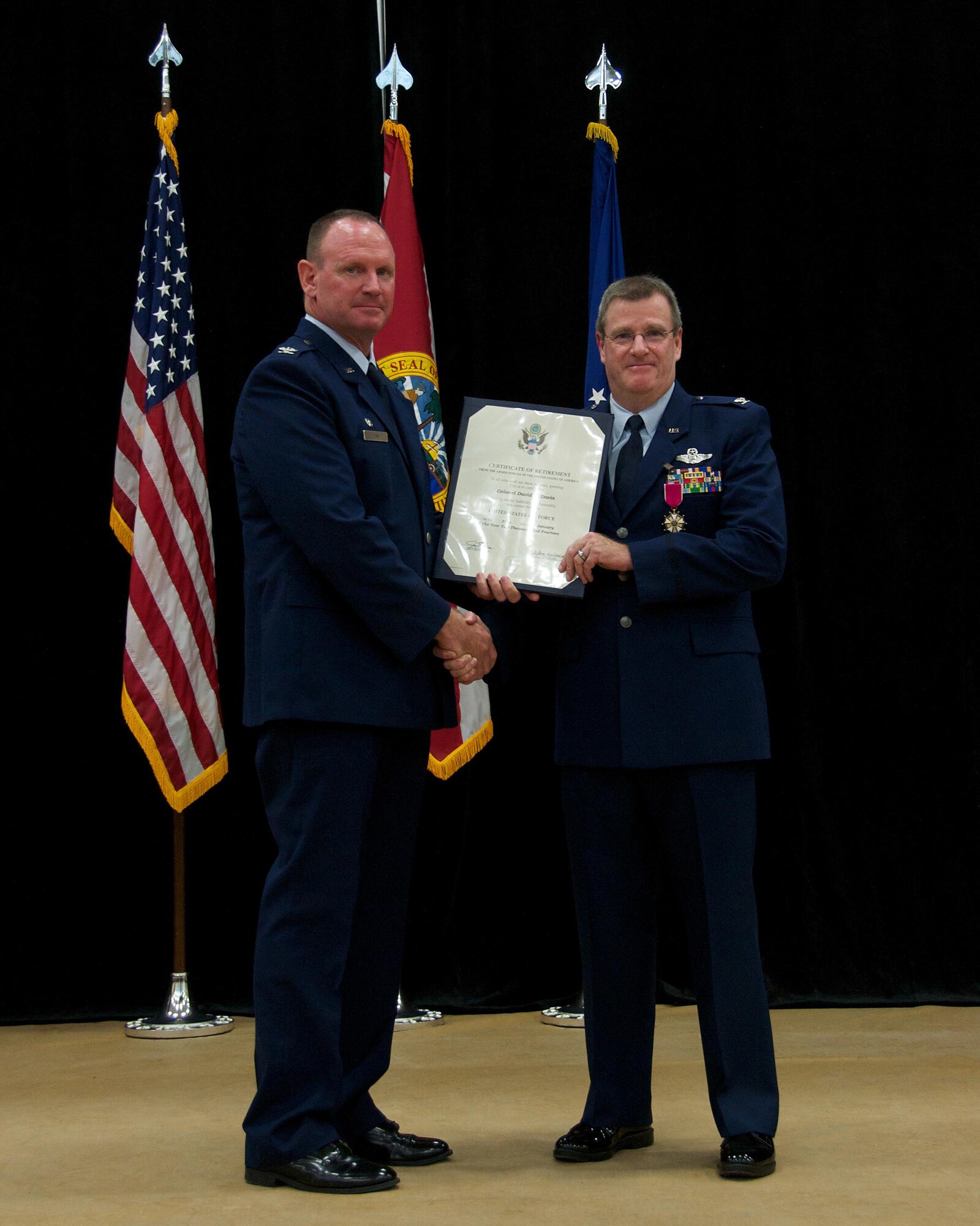 Col. Chris Funk, 482nd Fighter Wing commander, poses for a photo with Col. David Davis, 482nd Fighter Wing vice commander, after presenting him with a certificate of retirement during Davis’ retirement ceremony at Homestead Air Reserve Base, Fla., Jan. 11. Davis officially retires Jan. 31. (U.S. Air Force photo by/Senior Airman Jaimi L. Upthegrove)