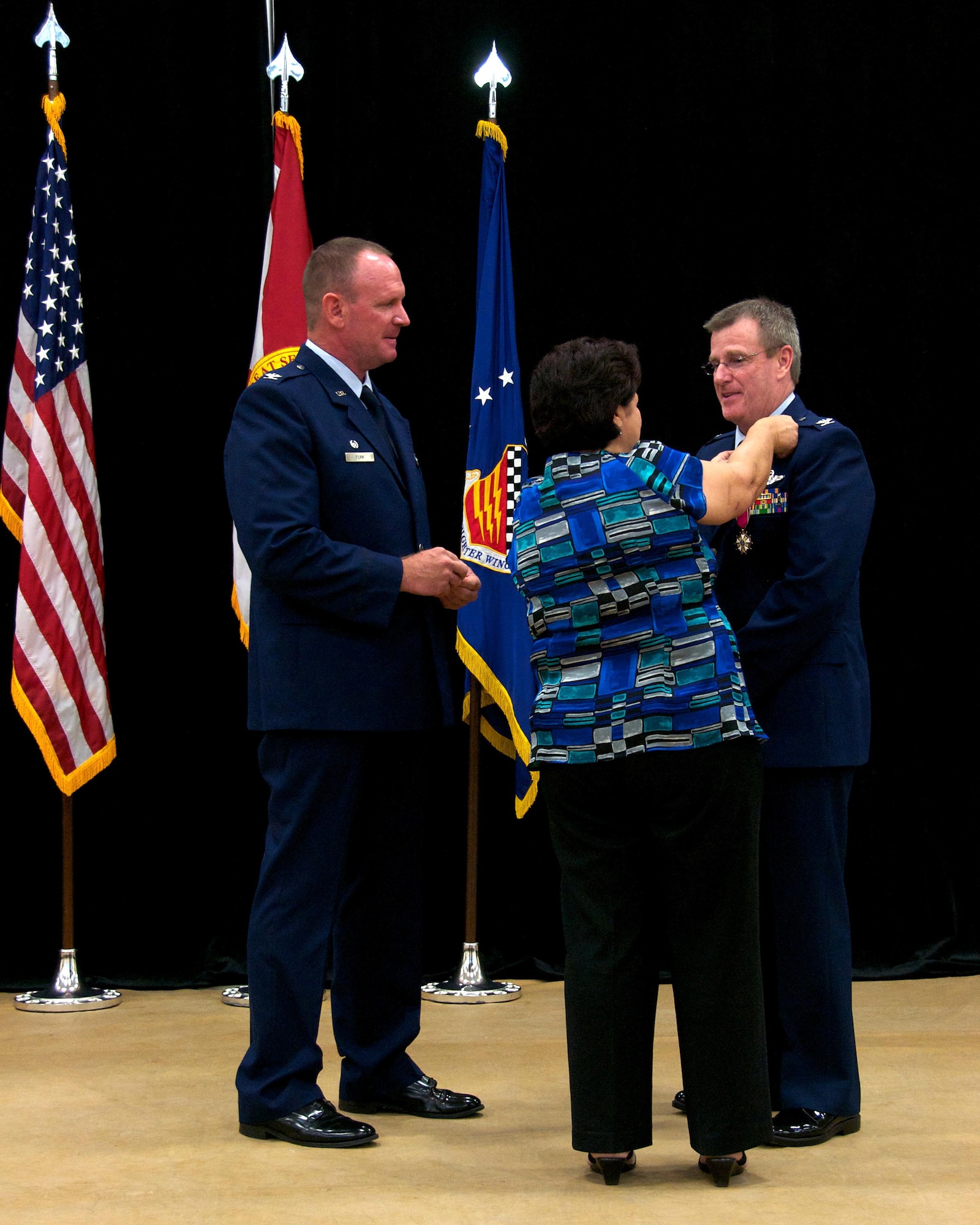 Col. Chris Funk, 482nd Fighter Wing commander, presents Col. David Davis, 482nd FW vice commander, with his retirement pin which is pinned on by Davis’ wife, Cindi Davis, during his retirement ceremony at Homestead Air Reserve Base, Fla., Jan. 11. Davis officially retires Jan. 31. (U.S. Air Force photo by/Senior Airman Jaimi L. Upthegrove)