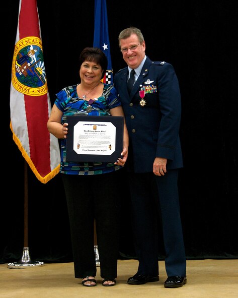 Cindi Davis poses with her husband, Col. David Davis, 482nd Fighter Wing vice commander, after being presented the Military Spouse Medal during Col. Davis’ retirement ceremony at Homestead Air Reserve Base, Fla., Jan. 11. Davis officially retires Jan. 31. (U.S. Air Force photo by/Senior Airman Jaimi L. Upthegrove)