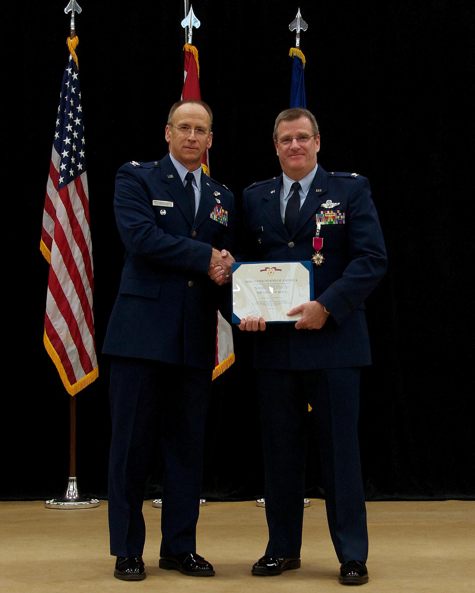 Col. Donald Lindberg, 10th Air Force vice commander, awards the Legion of Merit medal to Col. David Davis, 482nd Fighter Wing vice commander, during Davis’ retirement ceremony at Homestead Air Reserve Base, Fla., Jan. 11. Davis officially retires Jan. 31. (U.S. Air Force photo by/Senior Airman Jaimi L. Upthegrove)
