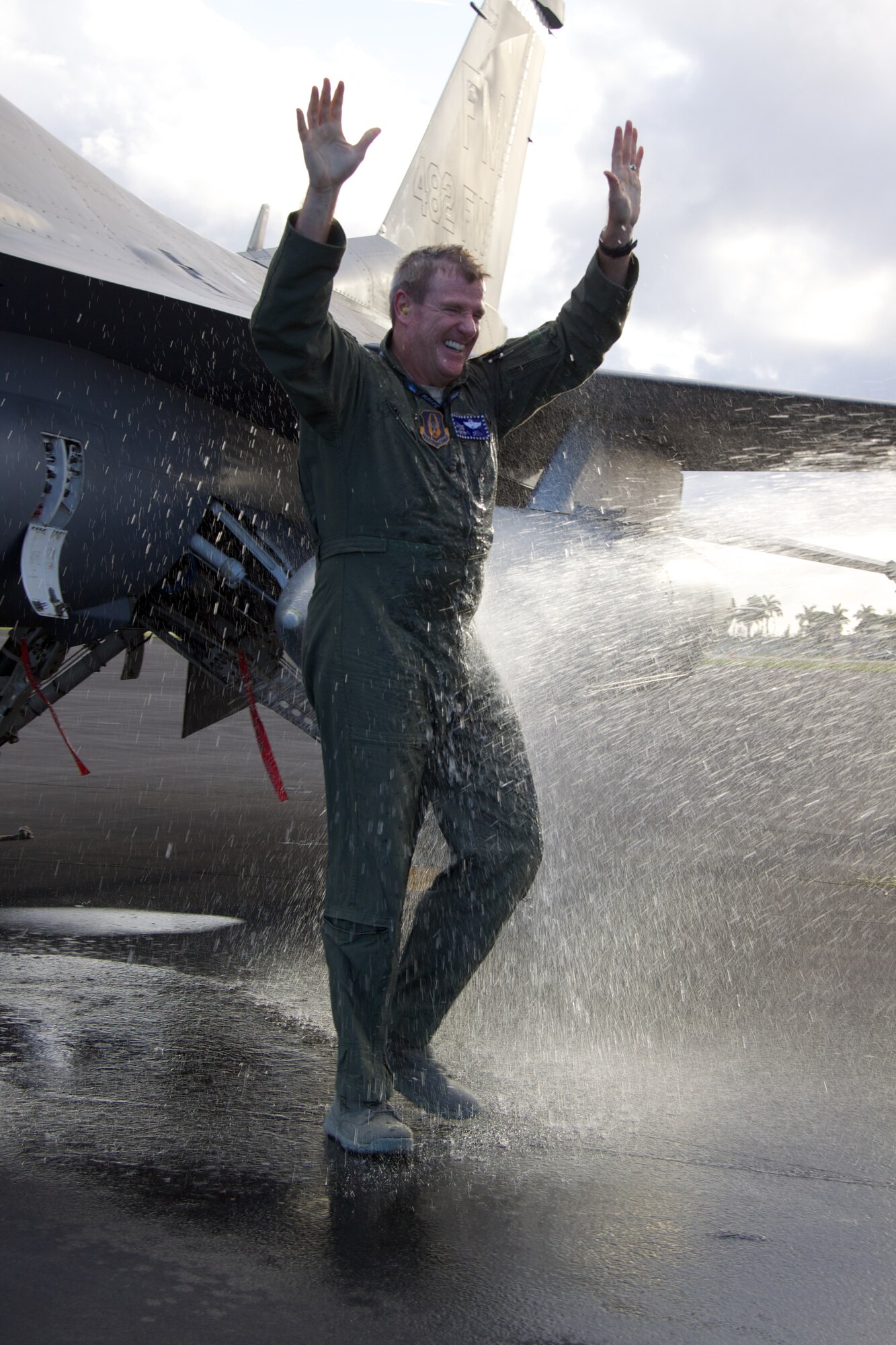 Col. David Davis, 482nd Fighter Wing vice commander, exits his jet for the last time while being hosed down with water by his family at Homestead Air Reserve Base, Fla., Jan. 10. This was immediately following Davis’ “fini-flight”, the final flight in a pilot’s career. Davis officially retires Jan. 31. (U.S. Air Force photo by/Tech. Sgt. Lionel Castellano)