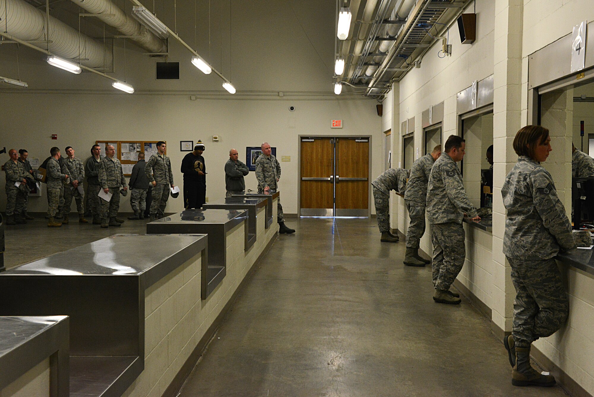 U.S. Air Force Airmen stand in line and wait to be issued gas masks at the Chandler Deployment Processing Center, Shaw Air Force Base, S.C., Jan. 9, 2014.  Approximately 815 Airmen went to the DPC over the course of four days to pick up their gas masks in preparation for an operational readiness exercise. (U.S. Air Force photo by Airman 1st Class Jensen Stidham/Released)
