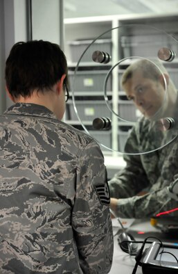 Capt. Richard Smith, 86th Medical Group officer in charge of the pharmacy, counsels a customer on medication requirements, Jan. 9, 2014, Ramstein Air Base, Germany. Smith is one of nine medical personnel who have been recognized for excellent performance in a recent accreditation inspection. (U.S. Air Force photo/Airman Larissa Greatwood)