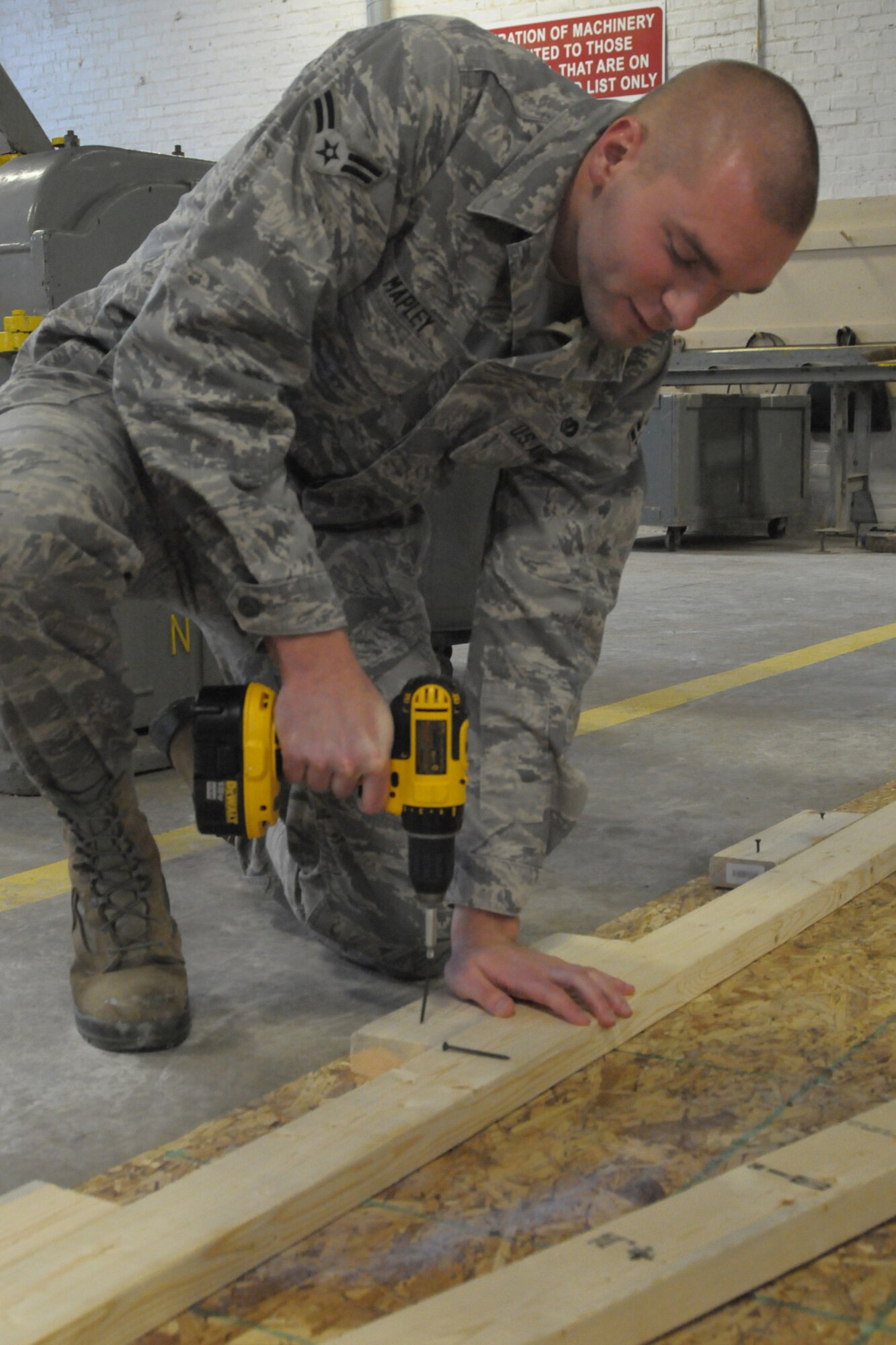 140112-Z-YW189-021-  Airman 1st Class Andrew Mapley, a structural journeyman in the 127th Civil Engineer Squadron, uses a drill to build a truss at Selfridge Air National Guard Base, Mich., January 12, 2013.   (U.S. Air National Guard photo by Staff Sgt. Samara Taylor/Released)