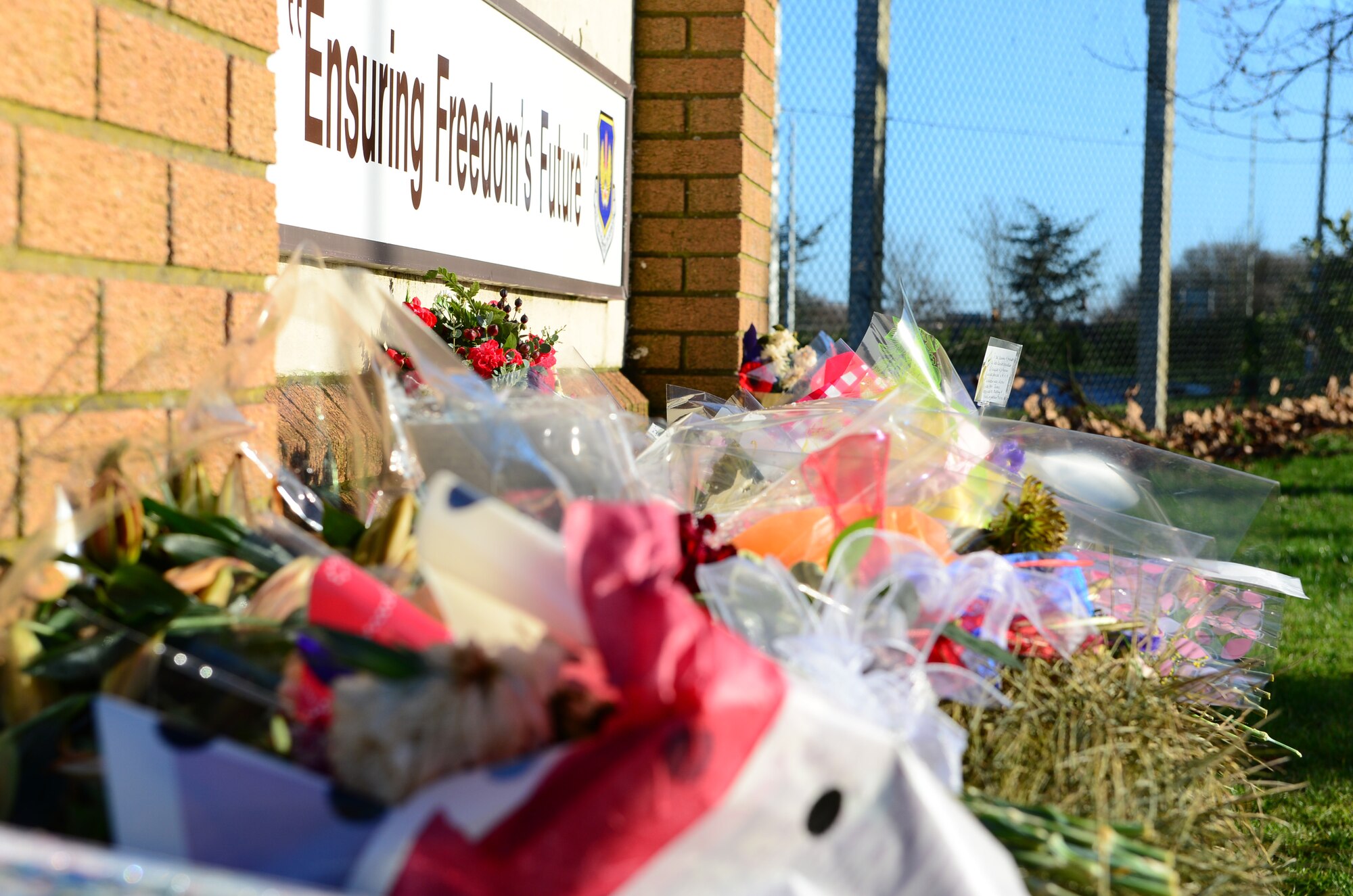 Members of surrounding communities have placed flowers at the entrance to Royal Air Force Lakenheath, England, in wake of the HH-60G Pave Hawk helicopter crash that killed four Airmen. Anyone in the United Kingdom or elsewhere outside the United States wishing to send condolence cards or messages may send them to 48th Fighter Wing Public Affairs, RAF Lakenheath, Brandon, Suffolk IP27 9PN or to 48FW.PA@us.af.mil. (U.S. Air Force photo by Airman 1st Class Dawn M. Weber)