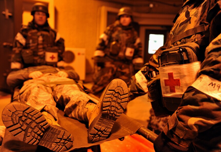 Members of the 51st Medical Group carry a simulated patient toward the Emergency Room during Operational Readiness Exercise Beverly Midnight 14-01 at Osan Air Base, Republic of Korea, Jan. 13, 2014. Personnel from the 51st MDG were evaluated on their capability to cooperate with multiple teams and provide appropriate care for patients with different levels of injury intensity. (U.S. Air Force photo/Senior Airman Siuta B. Ika)