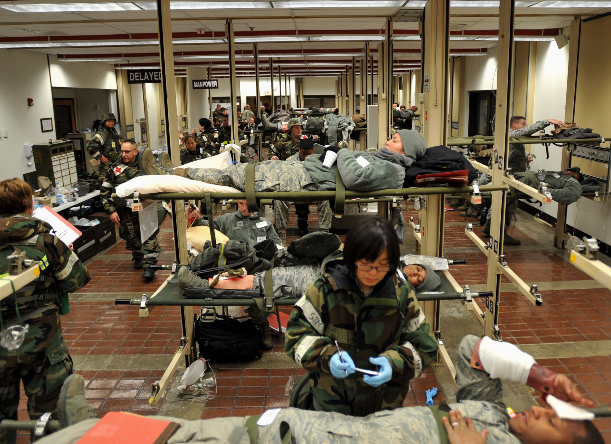 Personnel from the 51st Medical Group monitor simulated casualties in the 51st MDG Garden Center during Operational Readiness Exercise Beverly Midnight 14-01 at Osan Air Base, Republic of Korea, Jan. 13, 2014. Patients were housed in the Garden Center after having an initial injury assessment and before receiving further medical care. (U.S. Air Force photo/Senior Airman Siuta B. Ika)