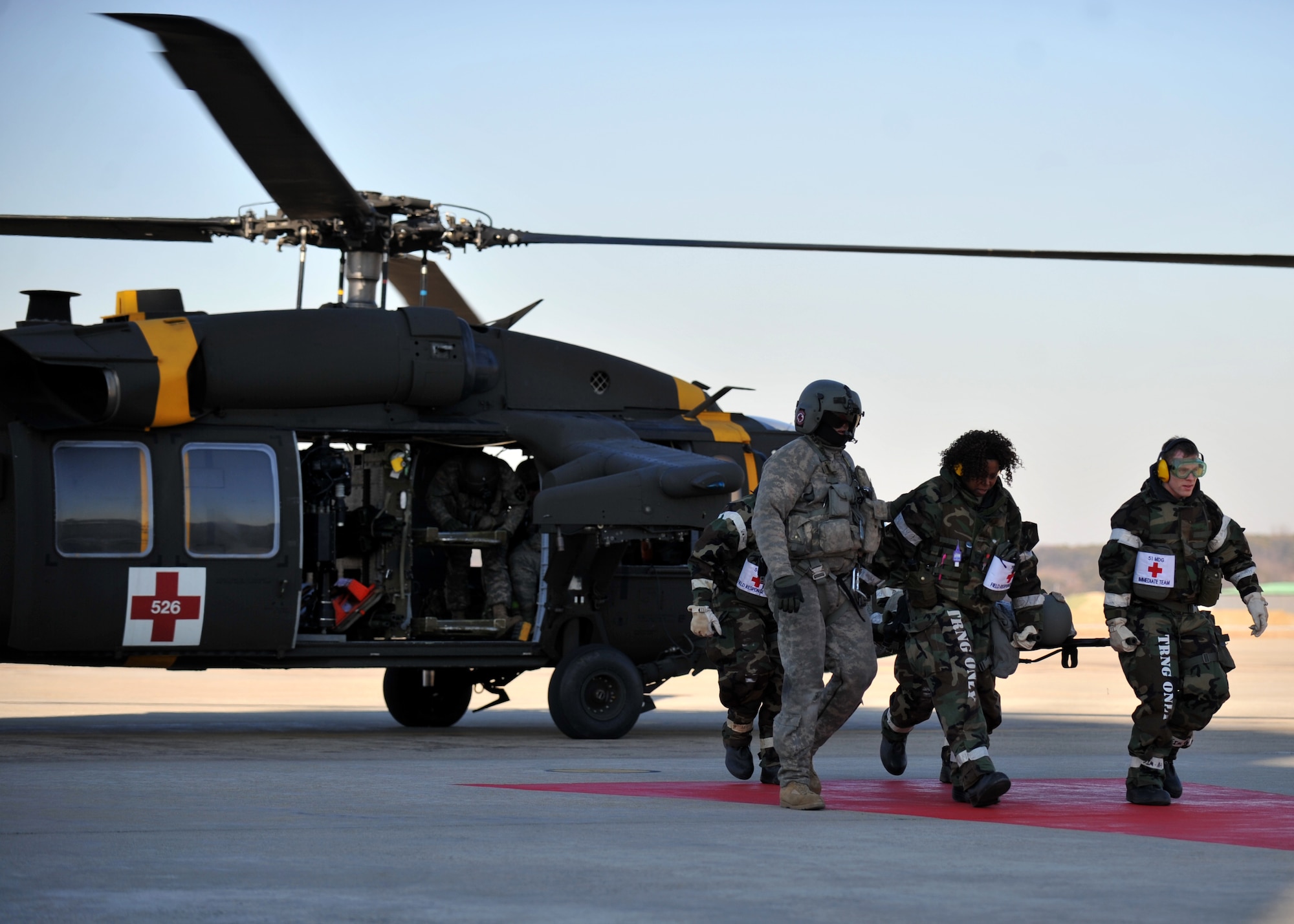 Members of the 51st Medical Group transport a simulated casualty from a medical evacuation helicopter toward the group’s triage center during Operational Readiness Exercise Beverly Midnight 14-01 at Osan Air Base, Republic of Korea, Jan. 13, 2014. The team worked with other first responders to effectively manage a multiple-casualty situation while wearing Mission Oriented Protective Posture Level 2 gear. (U.S. Air Force photo/Senior Airman Siuta B. Ika)
