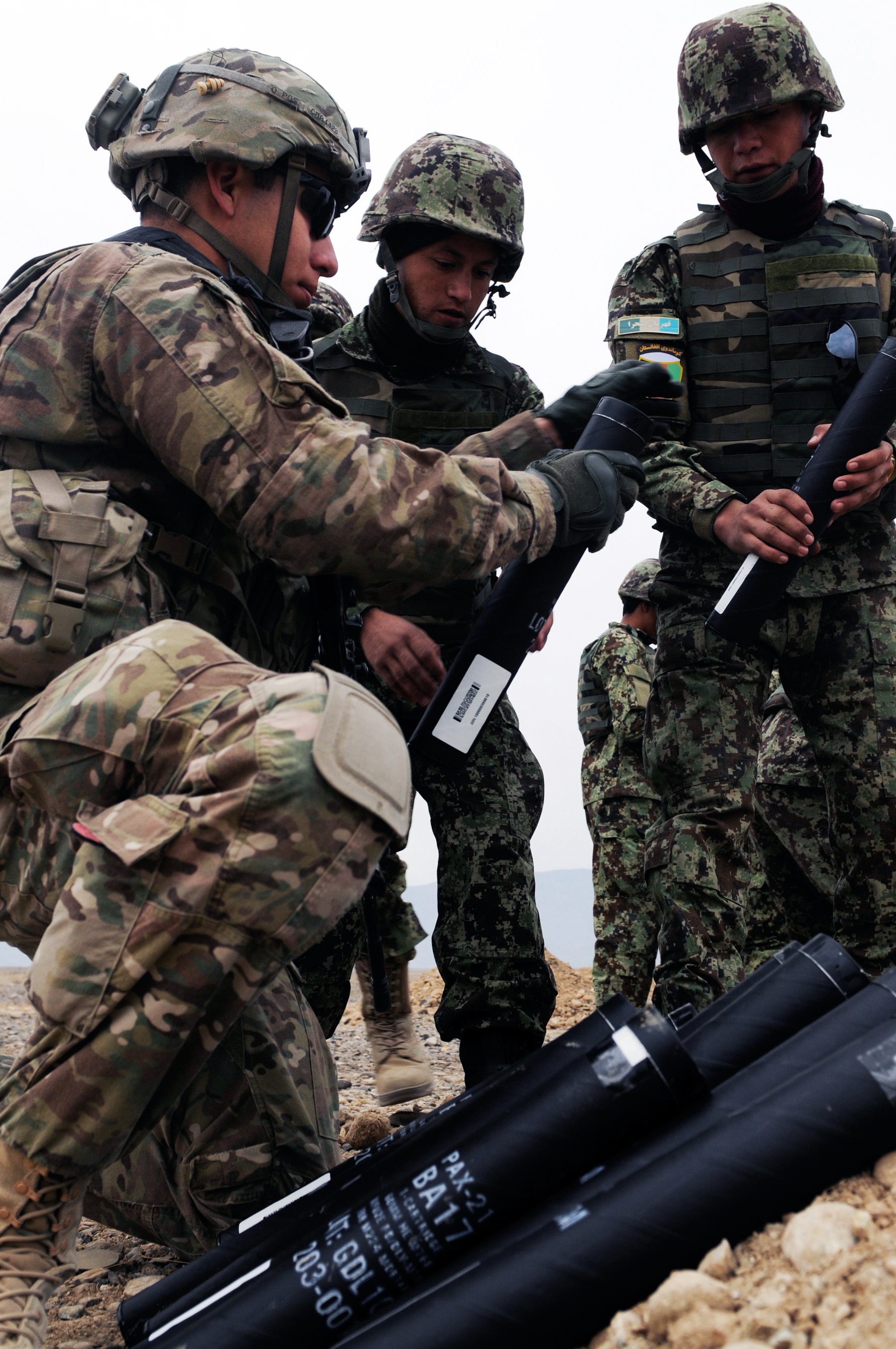 U S Army Spc Anthony Barajas Helps Afghan Soldiers Prepare 60mm Mortar Rounds During Training On Forward