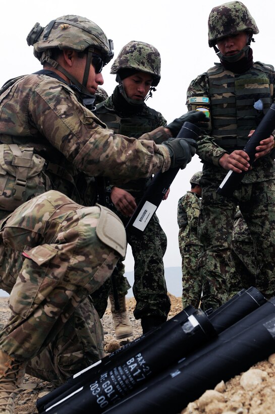 U.S. Army Spc. Anthony Barajas helps Afghan soldiers prepare 60mm mortar rounds during training on Forward Operating Base Gamberi in Afghanistan's Laghman province, Jan. 8, 2014. U.S. soldiers are assigned to 2nd Battalion, 30th Infantry Regiment. The Afghan soldiers are assigned to 4th Brigade, 201st Afghan National Army corps.