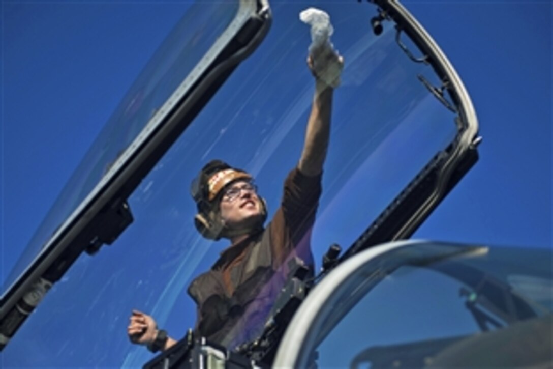 U.S. Marine Corps Cpl. Michael Mathisen cleans the canopy of an F/A-18C Hornet on the USS Harry S. Truman in the Gulf of Oman, Jan. 10, 2014. The Truman, flagship for the Harry S. Truman Carrier Strike Group, is deployed to the U.S. 5th Fleet area of responsibility conducting maritime security operations, supporting theater security cooperation efforts and Operation Enduring Freedom. 